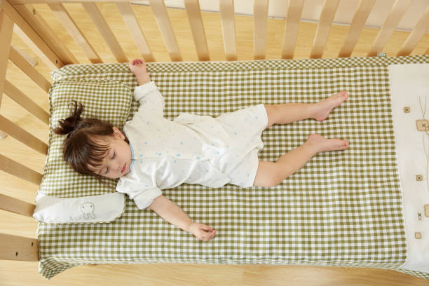 The beautiful little girl fell asleep on the children's bed